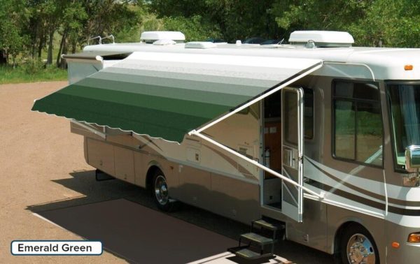A RV with an extended awning labeled "Emerald Green"