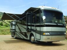 A RV in the country with an extended eclipse patio awning