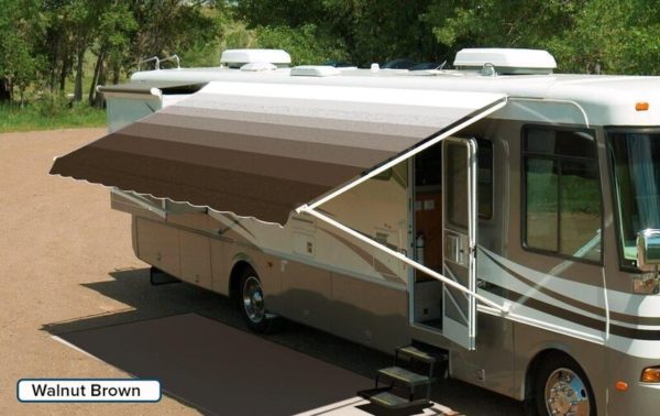 A RV with an extended awning labeled "Walnut Brown"