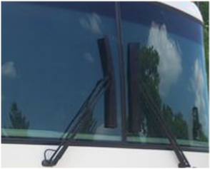 The windshield of a RV with wiper covers on the wipers