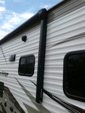 The side of a RV with a complete awning