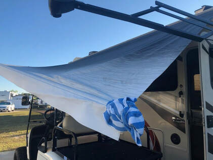 A broken RV awning after suffering wind damage