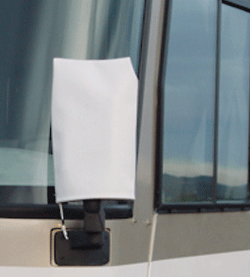 An RV and side mirror, with a white mirror sock